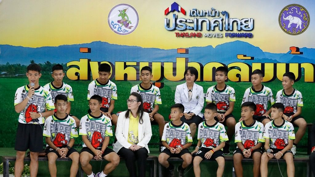 Coach” Ake” Ekkapol Janthawong, left, speaks on behalf of the 12 boys and himself and their cave rescue during a press conference discussing their ordeal in Chiang Rai, northern Thailand, Wednesday, July 18, 2018.&nbsp;
