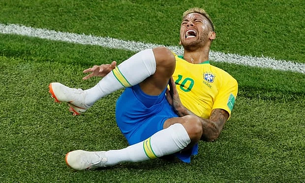 Neymar grimaces with pain.