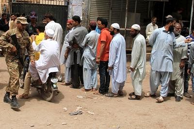 KARACHI, July 25, 2018 (Xinhua) -- Voters wait to cast ballot at a polling station during the general elections in southern Pakistani port city of Karachi, on July 25, 2018. Pakistan held the general elections on Wednesday. (Xinhua/Stringer/IANS)