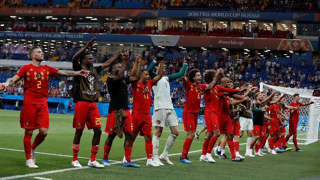 The Belgium team celebrates with fans after its last gasp win over Japan