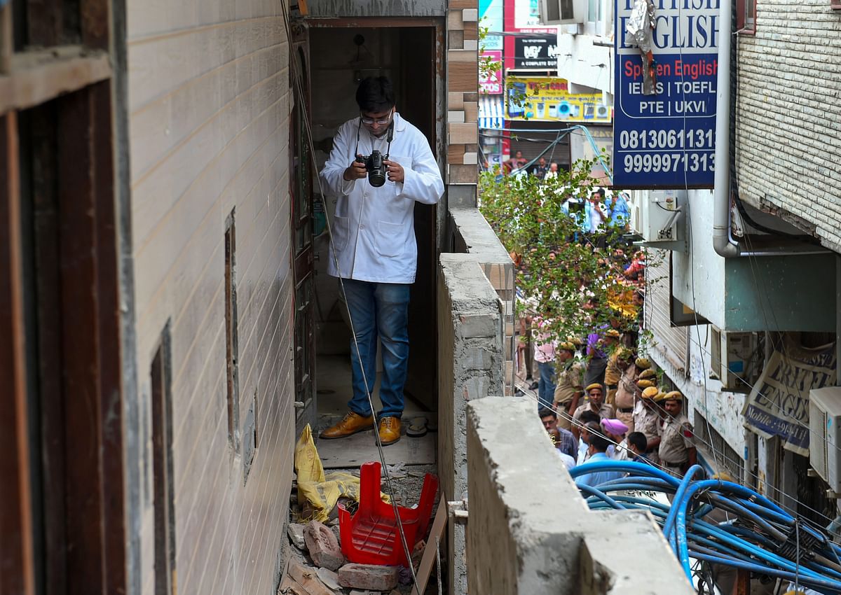A forensic expert inspects the house, where 11 members of a family were found dead in Burari area of Delhi on 1 July. &nbsp;