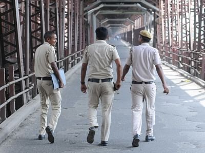 New Delhi: Police personnel carry out surveillance at the old Yamuna rail bridge that was closed for train traffic since Sunday night as a precautionary measure after the river crossed the danger-mark, in New Delhi on July 30, 2018. The traffic has now been restored on the bridge. (Photo: IANS)
