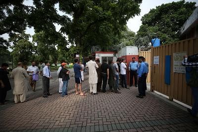 ISLAMABAD, July 25, 2018 (Xinhua) -- People stand in queue to cast their votes outside a polling station in Islamabad, capital of Pakistan, on July 25, 2018. Pakistanis started casting votes in the country