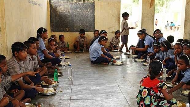 Students having their Mid-Day Meal in school
