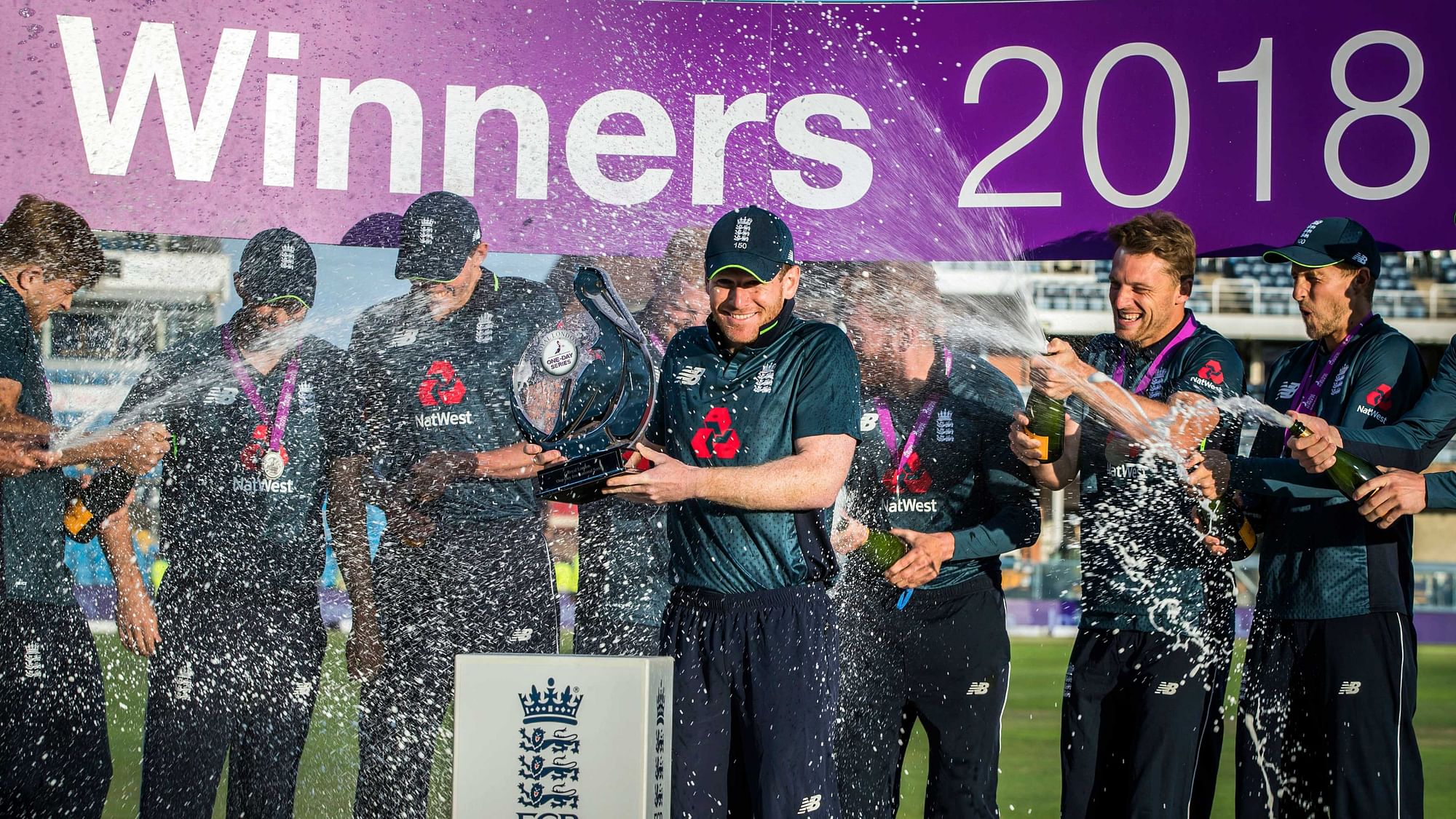 Eoin Morgan holds the trophy as he celebrates winning the series with team mates following the third Royal London One Day international at Emerald Headingley, Leeds.