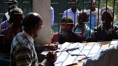 Villagers check their names on the draft of the Assam National Register of Citizens (NRC).