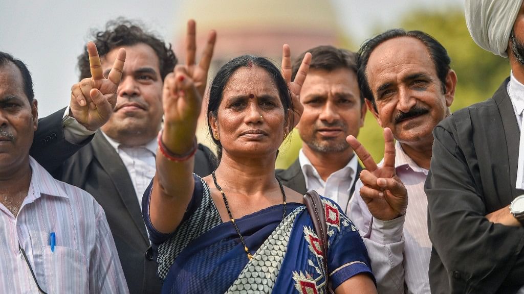  Nirbhayas parents show victory sign after the Supreme Courts verdict on Dec 2012 gang rape case, in New Delhi on Monday, July 9, 2018. 