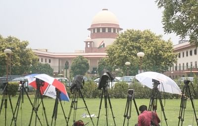 New Delhi: Media persons wait outside the Supreme court during the hearing on petitions against Section 377 of the Indian Penal Code that makes homosexuality a crime; in New Delhi on July 10, 2018. (Photo: IANS)
