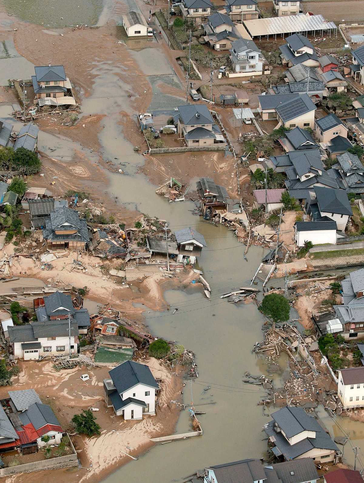 This photo shows an submerged housing area in Kurashiki, Okayama prefecture, western Japan Monday, July 9, 2018.