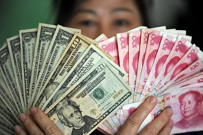 US Dollars and RMB banknotes. (File Photo: Xinhua/IANS)