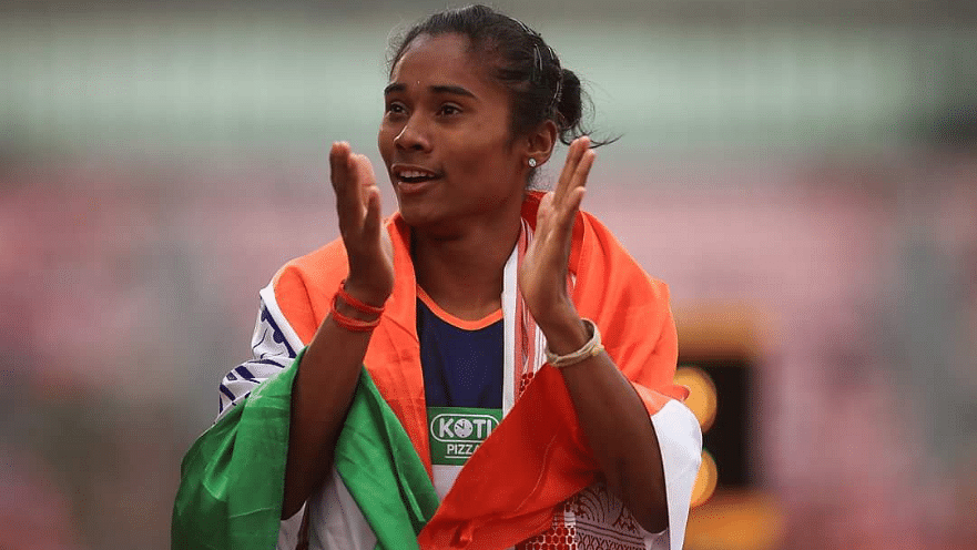 Hima Das celebrates with the Indian flag after winning her 400m Gold at the U-20 World Championships in Tampere, Finland