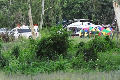 CHIANG RAI, July 10, 2018 (Xinhua) -- An evacuation helicopter and an ambulance are seen in Mae Sai district of Chiang Rai province, Thailand, July 10, 2018. All 12 boys and their football coach have been rescued from a flooded cave in northern Thailand after being trapped for 18 days, Thai navy SEALs confirmed on Tuesday. (Xinhua/Rachen Sageamsak/IANS)