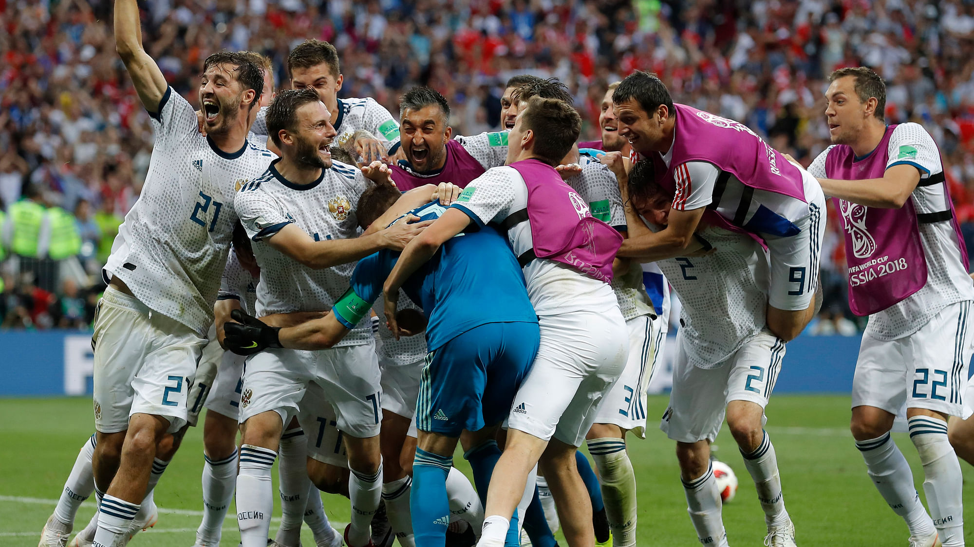 Russian players mob Russia goalkeeper Igor Akinfeev, front left in blue, after Russia defeated Spain by winning a penalty shoot in the round of 16 match between Spain and Russia at the 2018 FIFA World Cup at the Luzhniki Stadium in Moscow.