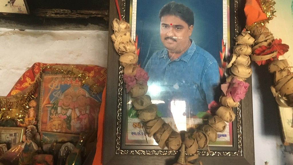 A picture of diamond polisher Bharatbhai Rathod who committed suicide last year hangs at his home in Damrala village in Bhavnagar, India, 31 January 2018.&nbsp;