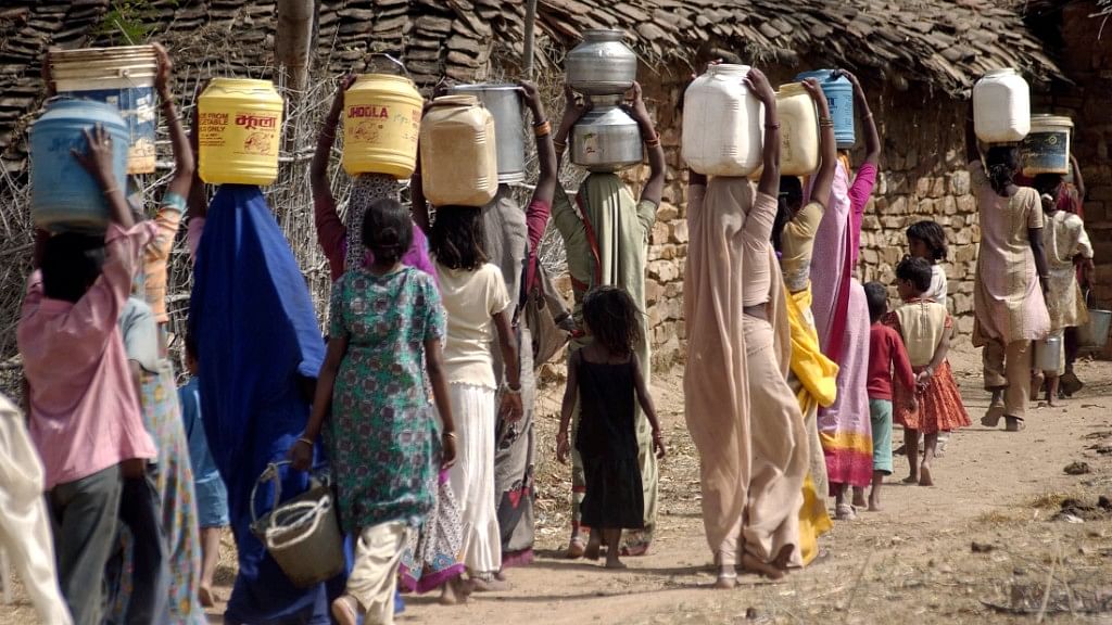 Villagers carry drinking water near Manikpur village in the Bundelkhand region of Uttar Pradesh.