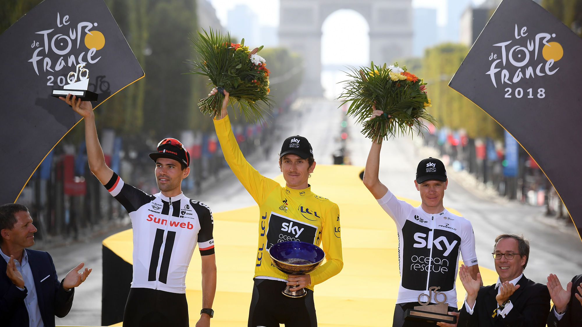 Britain’s Geraint Thomas, wearing the overall leader’s yellow jersey, second place Netherlands’ Tom Dumoulin, left, and third place Britain’s Chris Froome, celebrate on the podium after the twenty-first stage of the Tour de France cycling race over 116 kilometers (72.1 miles) with start in Houilles and finish on Champs-Elysees avenue in Paris, France, Sunday July 29, 2018.&nbsp;