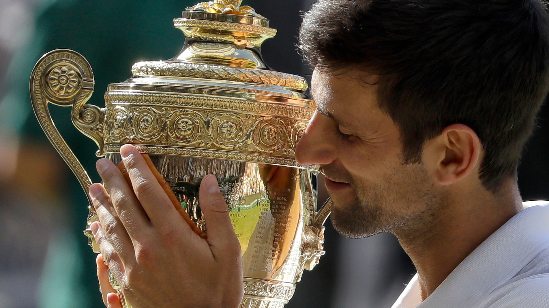 Serbia’s Novak Djokovic holds the trophy after winning the men’s singles final match against Kevin Anderson of South Africa, at the Wimbledon Tennis Championships, in London, Sunday July 15, 2018