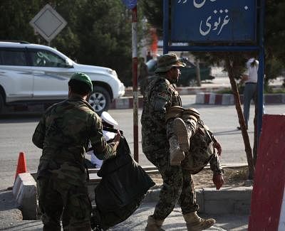 KABUL, July 22, 2018 (Xinhua) -- An Afghan security force member carries an injured man at the site of an attack in Kabul, capital of Afghanistan, July 22, 2018. Over two dozen people including civilians and police were killed and injured in a suicide attack that rocked Kabul on Sunday, an eyewitness said. (Xinhua/Rahmat Alizadah/IANS)
