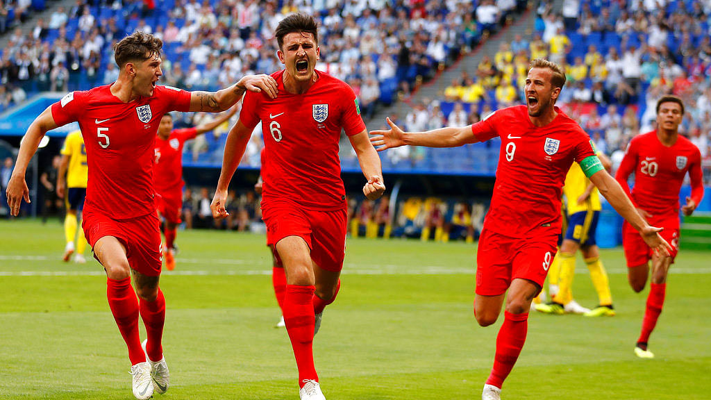 England’s Harry Maguire, center, celebrates with his teammates after scoring his side opening goal against Sweden.