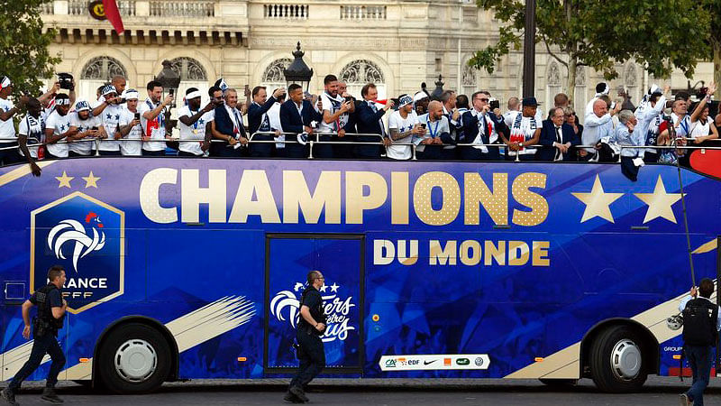 France’s players celebrate on the roof of a bus while parading down the Champs-Elysee avenue in Paris.