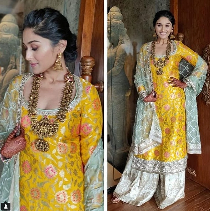 Poorna chose a mango yellow lehenga featuring mirror work for the <i>mehendi</i>. 