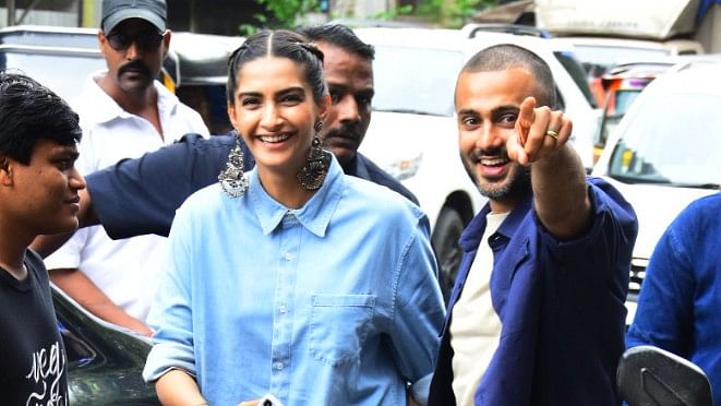 Sonam Kapoor along with husband, Anand Ahuja was spotted in Bandra, Mumbai for the puja of their new store. 