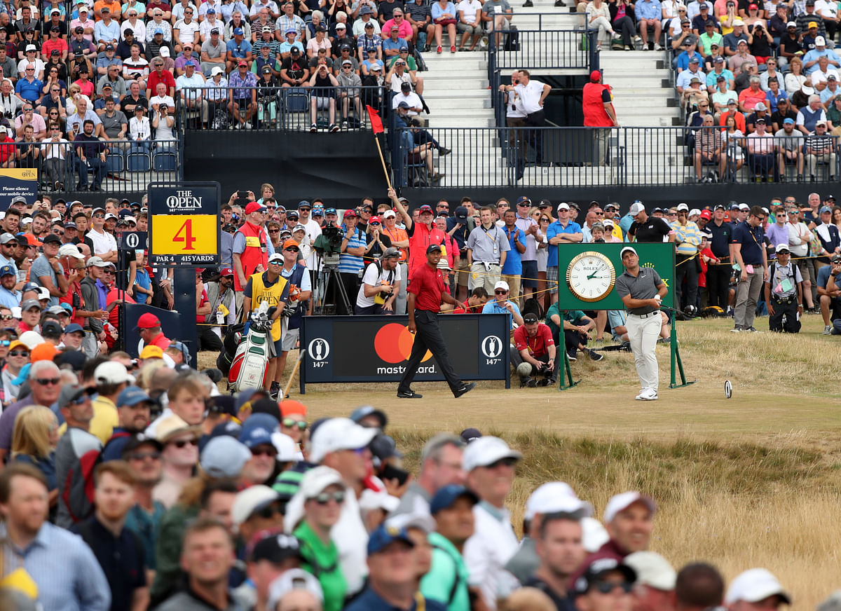 The Open: Woods topped the leaderboard until a double-bogey at the 11th and another dropped stroke at the next hole.