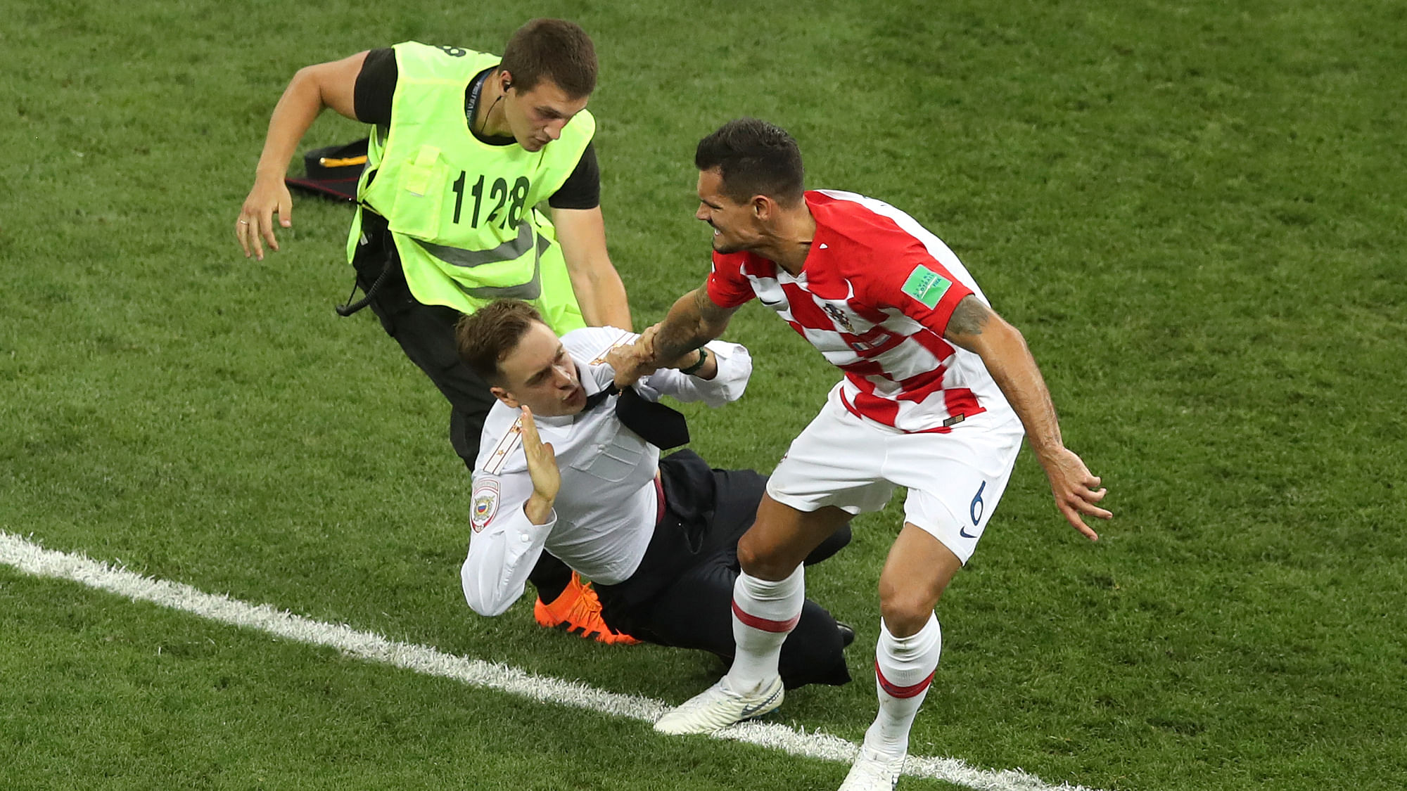 Croatia’s Dejan Lovren and a steward grab a man who invaded the pitch during the final match between France and Croatia at the 2018 soccer World Cup in the Luzhniki Stadium in Moscow, Russia, Sunday, July 15, 2018.&nbsp;