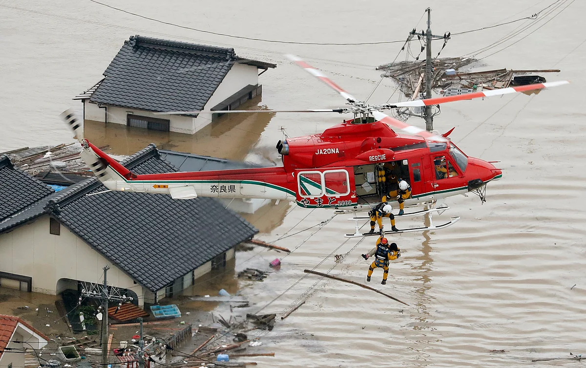 A resident is rescued in a flooded area in Kurashiki, Okayama prefecture, following heavy rain. 