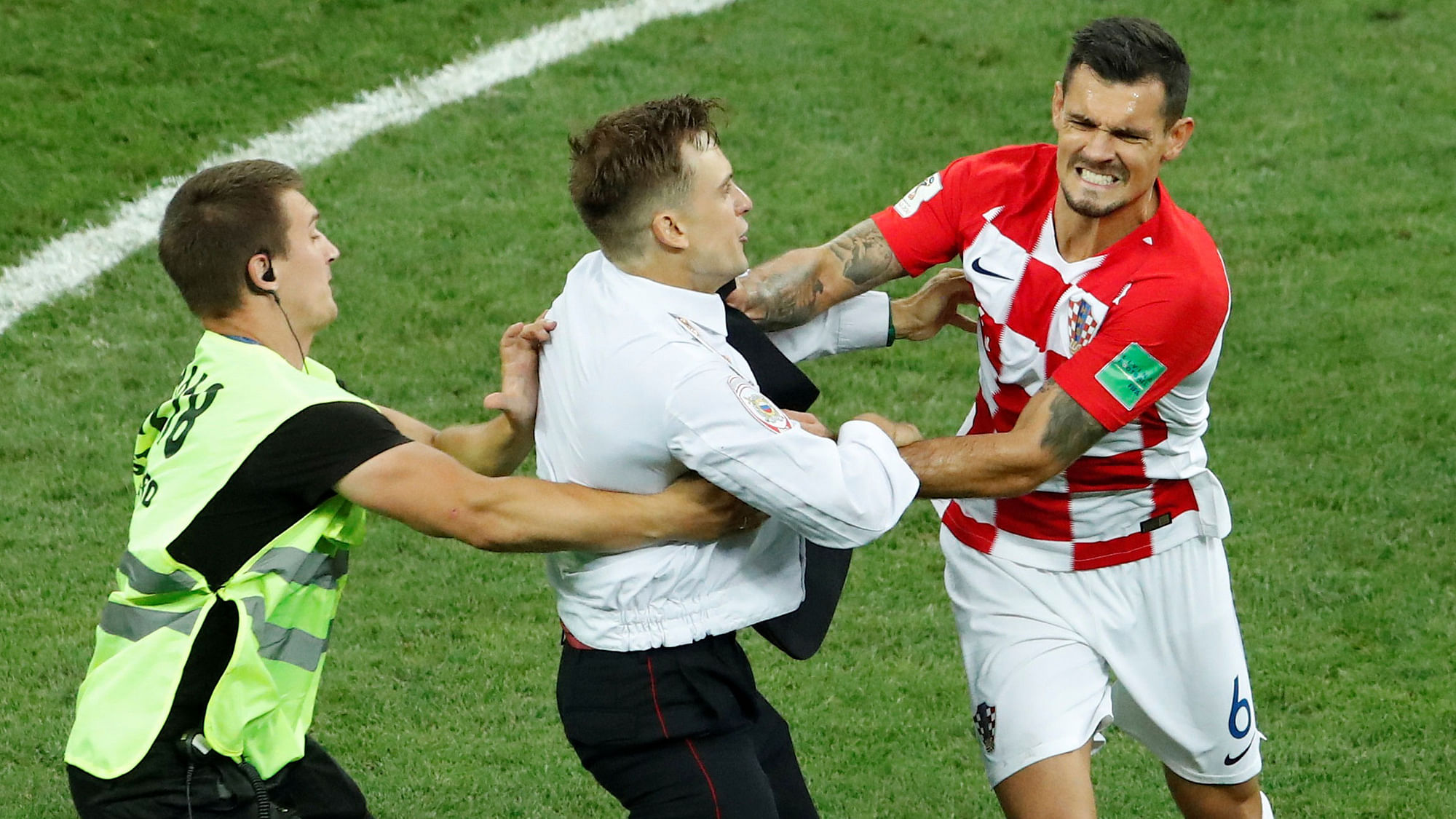 One of the members of the Pussy Riot group approaches Croatia’s Dejan Lovren during the FIFA World Cup final.