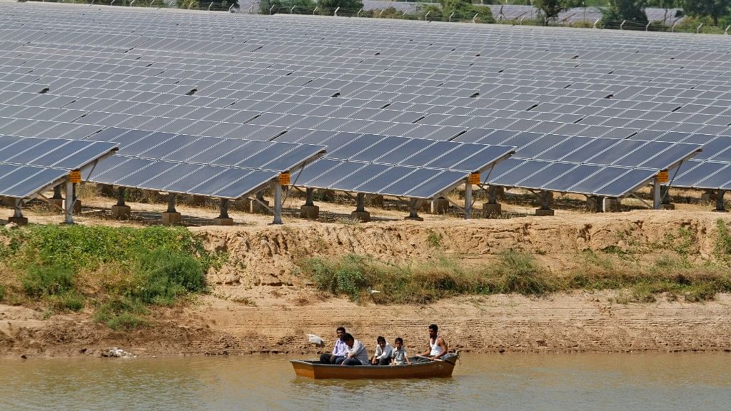 Security personnel sit in a boat as they patrol the premises of solar farm in Gujarat. Photo used for representational purposes.