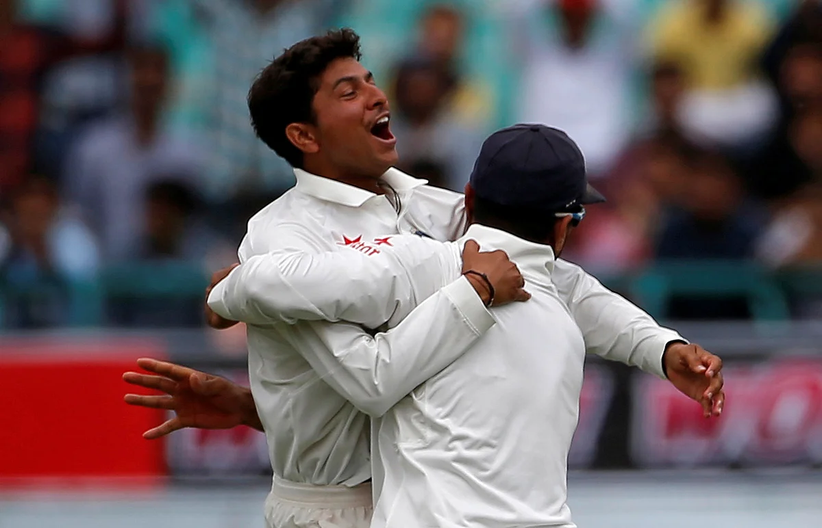 Kuldeep Yadav and Murali Vijay celebrate the dismissal of Australia’s Peter Handscomb in the former’s first Test match.
