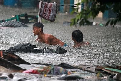 QUEZON CITY, July 17, 2018 (Xinhua) -- Residents wade through flood water brought by the heavy rain from tropical storm Son-Tinh in Quezon City, the Philippines, July 17, 2018. (Xinhua/Rouelle Umali/IANS)