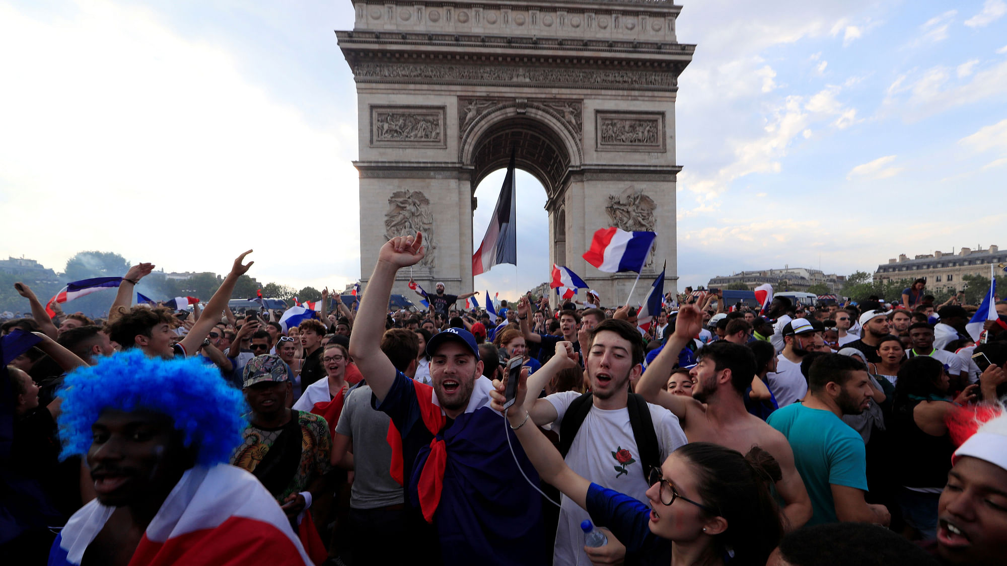 French fans celebrate on the Champs-Elysees avenue near the Arc de Triomphe after France defeated Croatia in the FIFA World Cup final on Sunday.