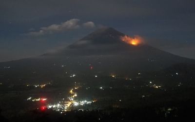 Bali's Agung volcano spews ash, smoke