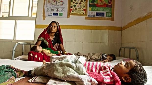 A lady waits for her child to be treated in a hospital.
