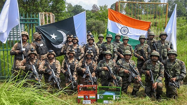 Indian and Pakistan Army exchange sweets on the occasion of Eid-al-Adha at Chakan Da Bagh Crossing point, near Poonch on Wednesday, 22 August 2018.   