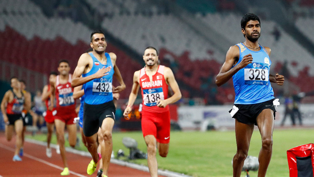 Jinson Johnson surges ahead to his pole finish in men’s 1500m run.