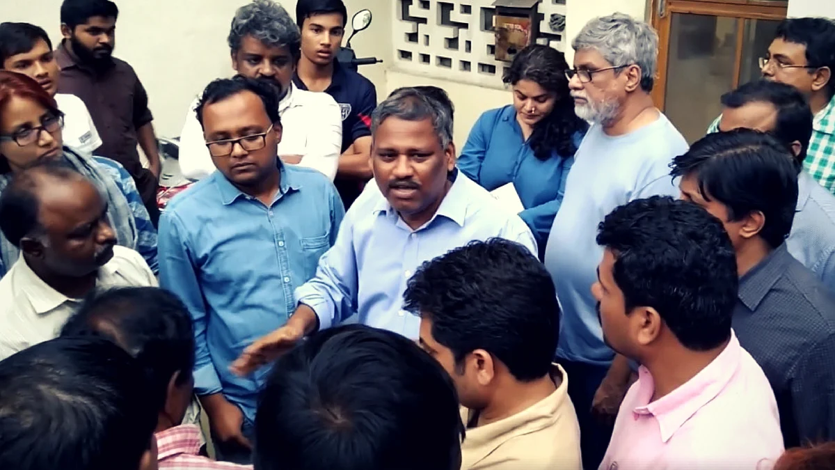 After the raid: Prof K Satyanarayana speaks to his friends outside his Hyderabad residence.