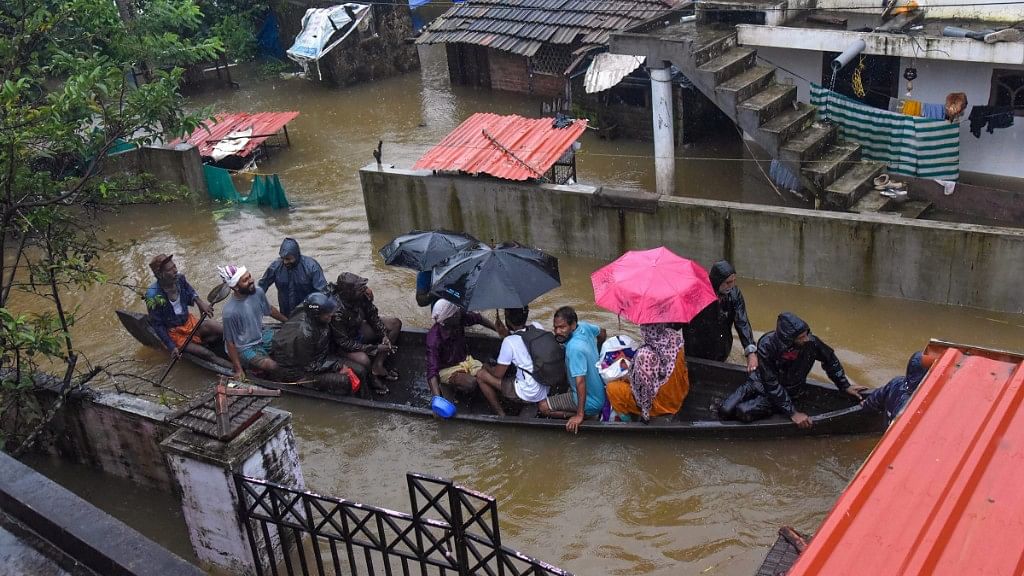  Rescue officials assist villagers out of a flooded area following heavy monsoon rainfall, near Kochi on Wednesday, Aug 15, 2018