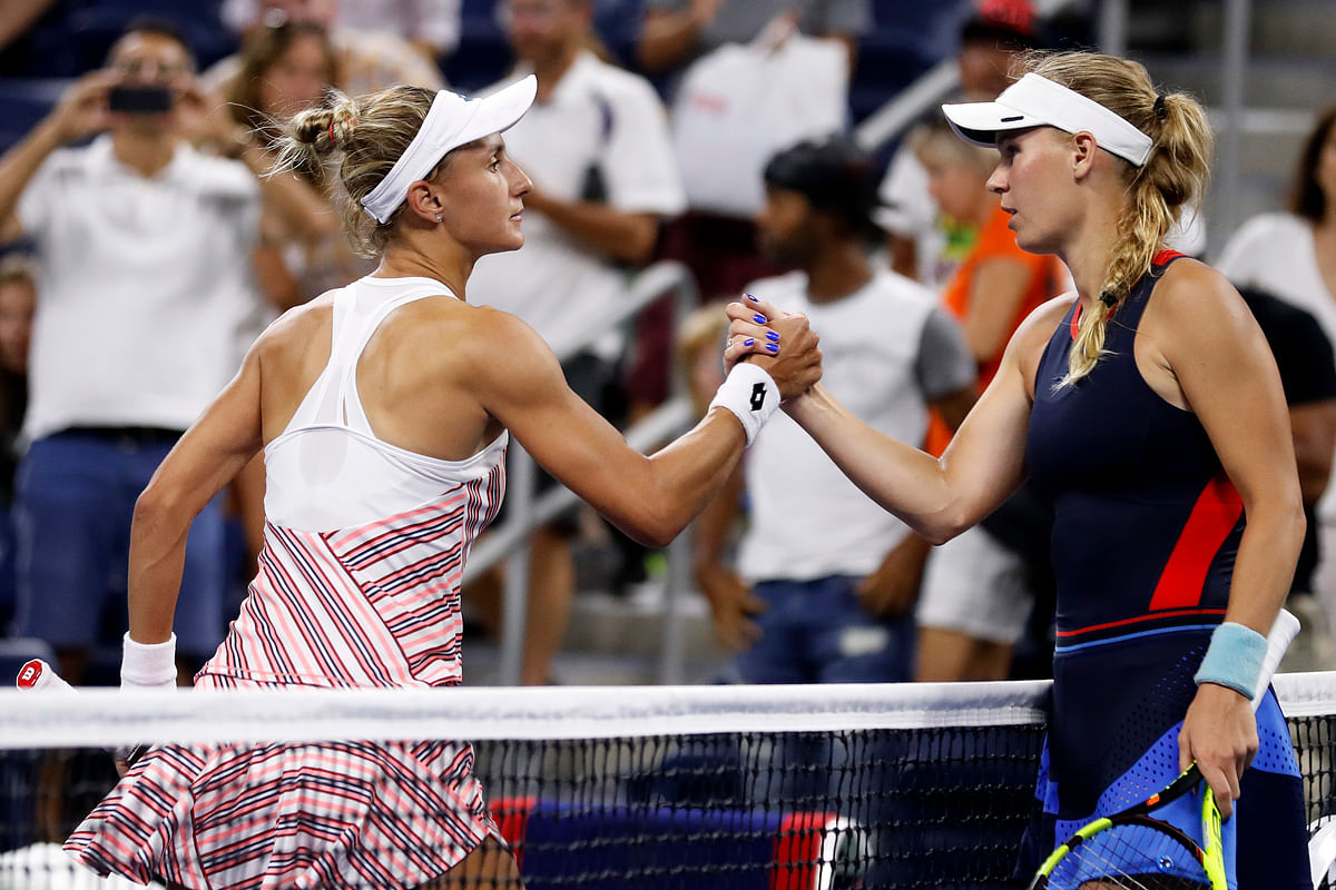 US Open: Reigning Australian Open champion Caroline Wozniacki lost 6-4, 6-2 to 36th-ranked Lesia Tsurenko.