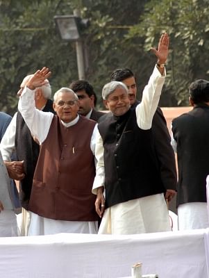 Atal Bihari Vajpayee with Nitish Kumar at his swearing-in ceremony in Patna. (Photo: File Photo: IANS)
