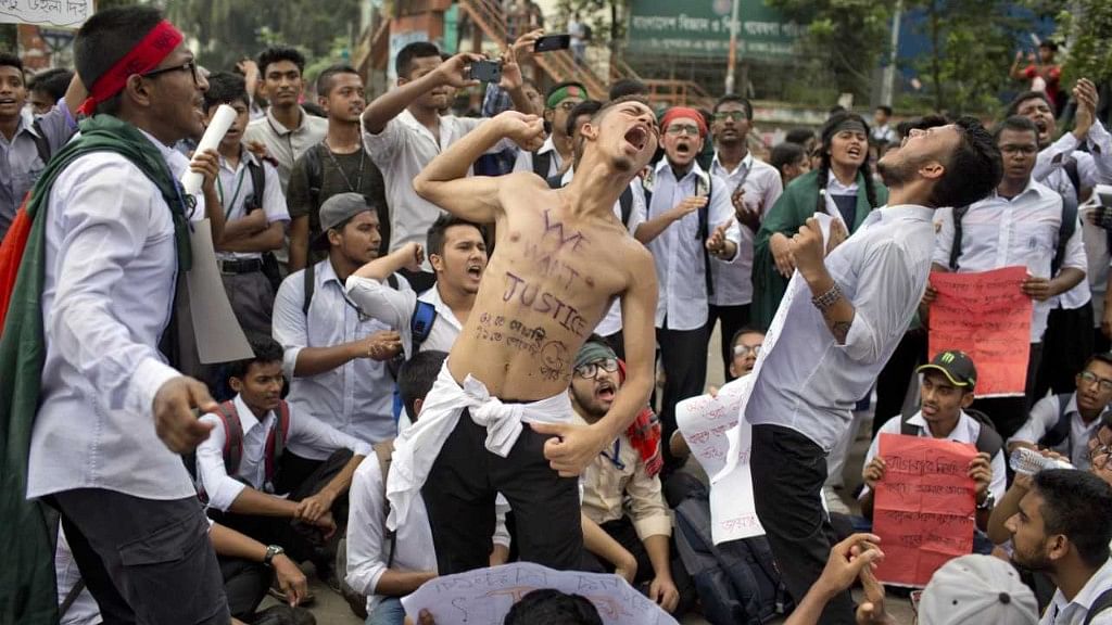 Bangladeshi students shout slogans and block a road during a protest in Dhaka on 4 August.