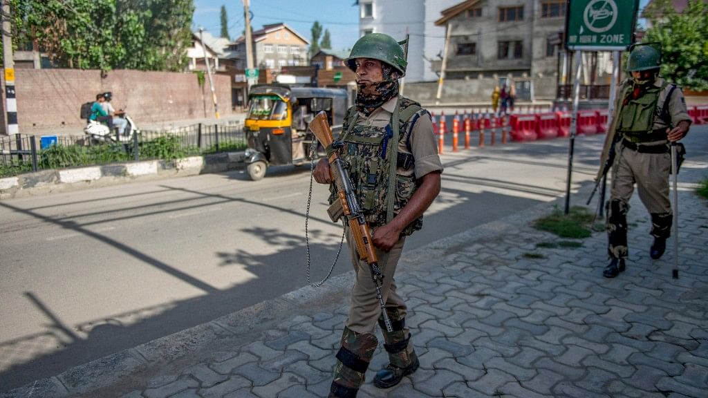  CRPF personnel patrol a street on the eve of Independence Day, in Srinagar on 14 August.