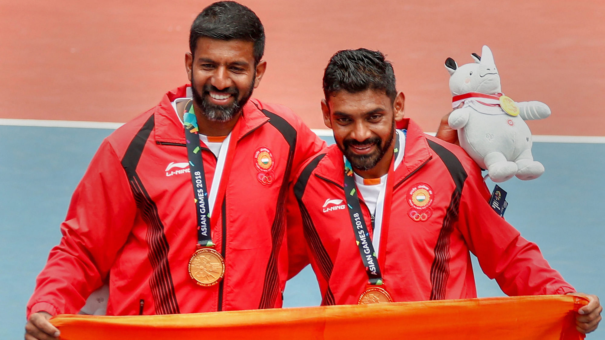 Palembang: Gold medalists Rohan Bopanna and Divij Sharan poses with the tricolour after the presentation ceremony for Men’s Double event at 18th Asian Games Jakarta Palembang 2018.