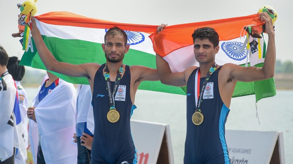 Indian rowers Rohit Kumar and Bhagwan Singh celebrate with the bronze medal after the medal ceremony for the Lightweight Mens Double Sculls.