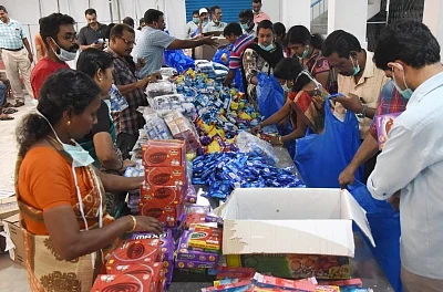 Kochi: Kochi corporation workers busy working at flood relief materials distribution center, in Kochi, on Aug 22, 2018. (Photo: IANS)