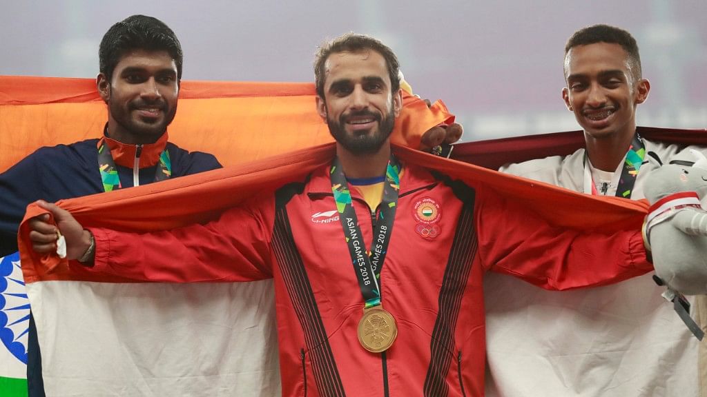  Manjit Singh (centre) stands with silver medalist and compatriot India’s Jinson Johnson (left) and bronze medalist Qatar’s Abubaker Abdalla on the podium at the 18th Asian Games on Tuesday.&nbsp;
