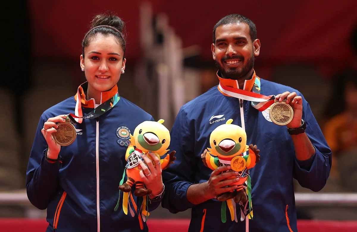 Manika Batra (L) and Sharat Kamal (R) after clinching bronze in their mixed doubles at the Jakarta Asian Games.