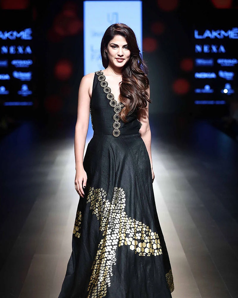 Rhea wore a black flowy dress embellished with gold that resembled a bird taking flight.